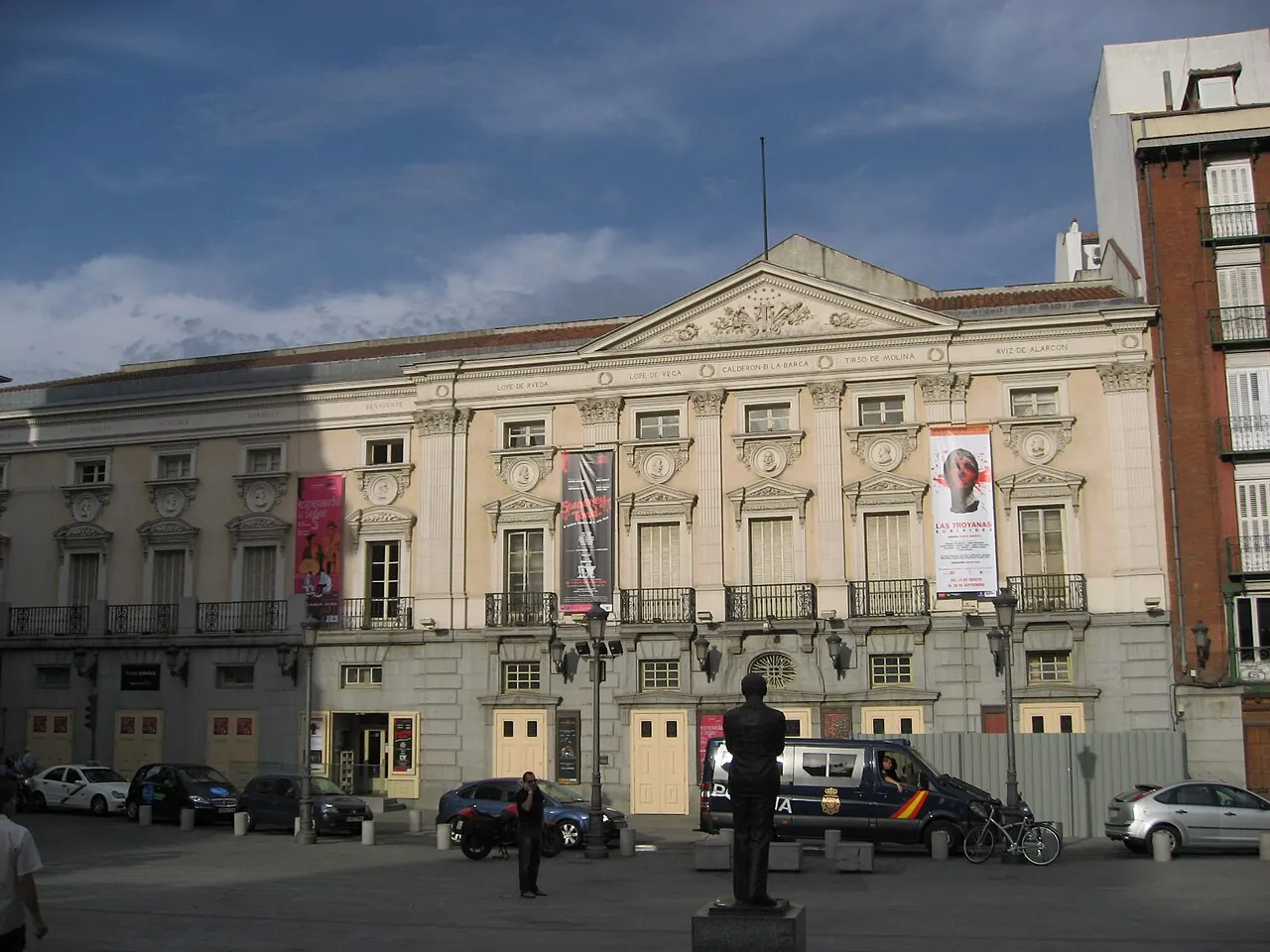 Plaza de Santa Ana in Madrid under a blue evening sky, with the pale front of Teatro Español behind a statue